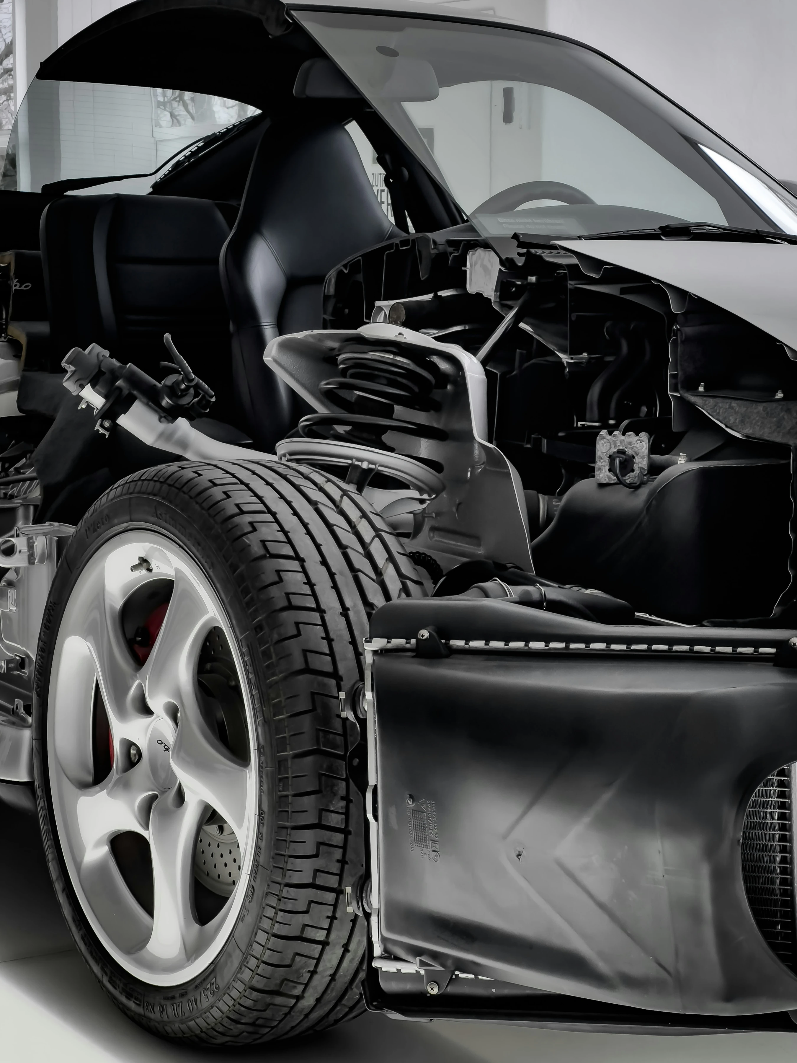 A cutaway car exposing its suspension, wheel and internal components